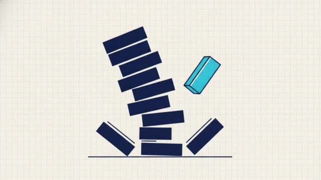 A stack of blocks mid-collapse with the lower blocks sliding out of alignment and one block falling clear